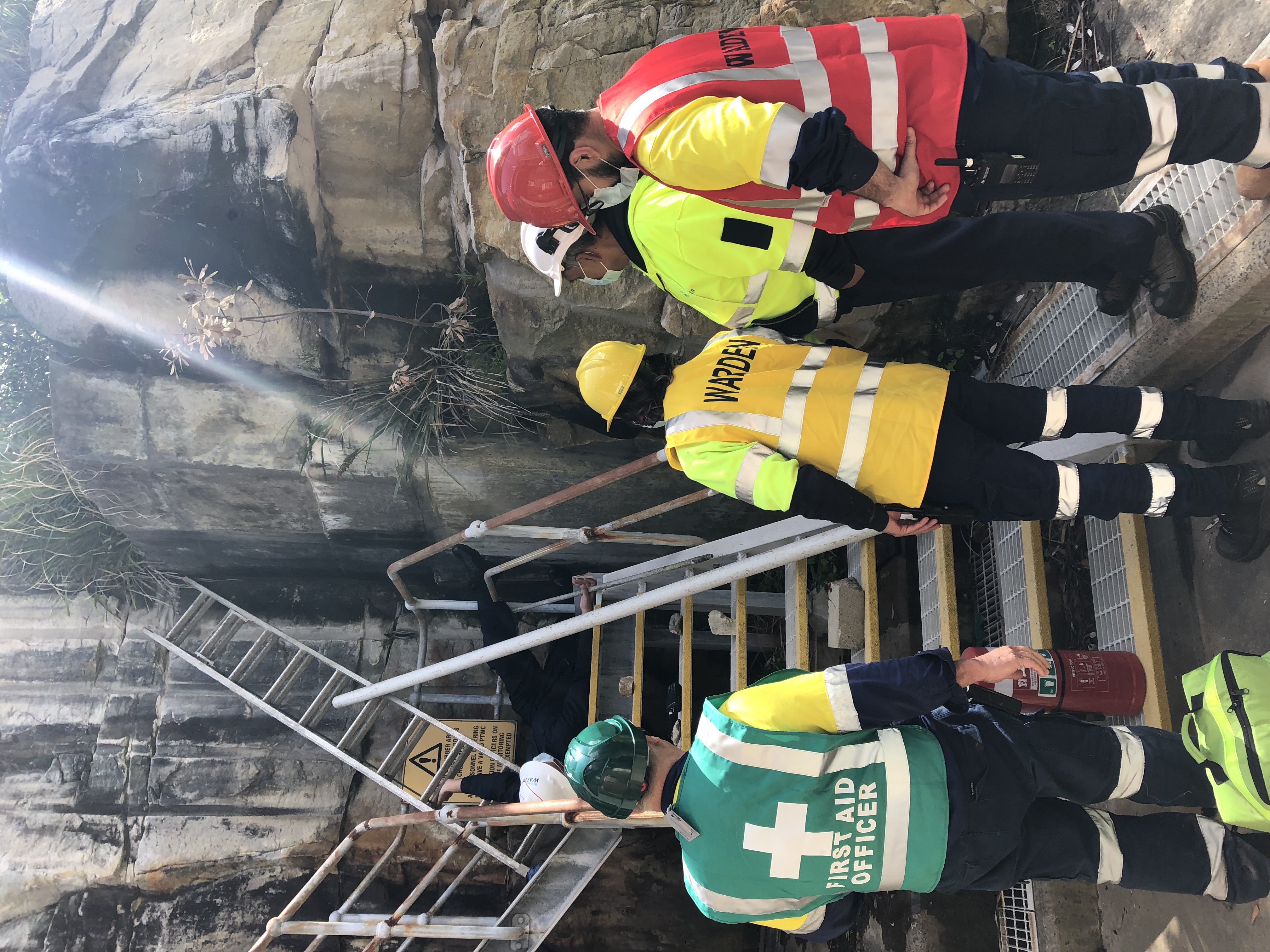 Wardens and a first aid officer on a stairway at a Sydney Water site